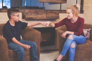 Foster Care Woman and Boy Child Talking inside a retro home