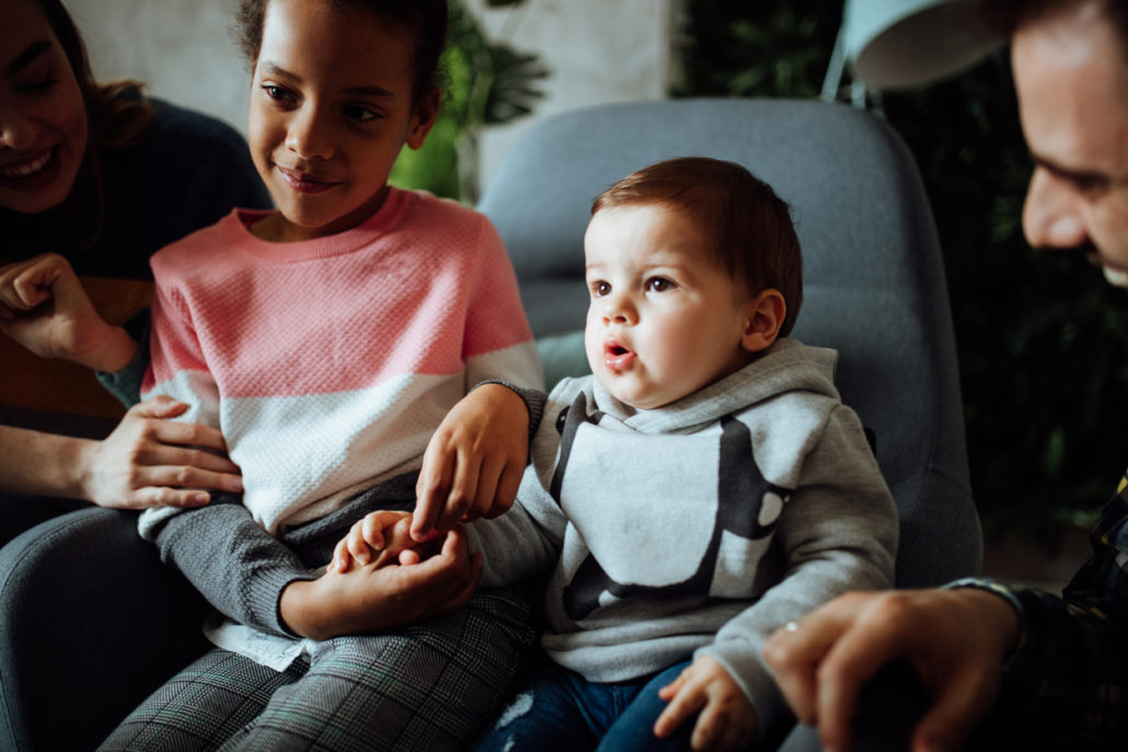 foster parent watching TV with foster children