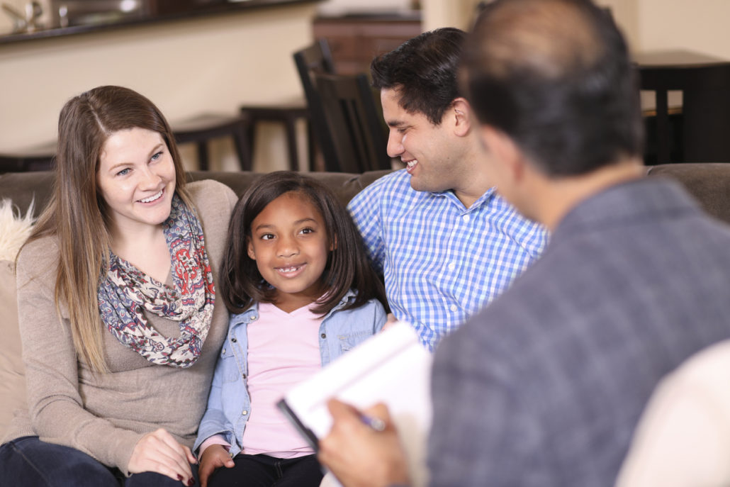 Family talking to foster agencies representative. 