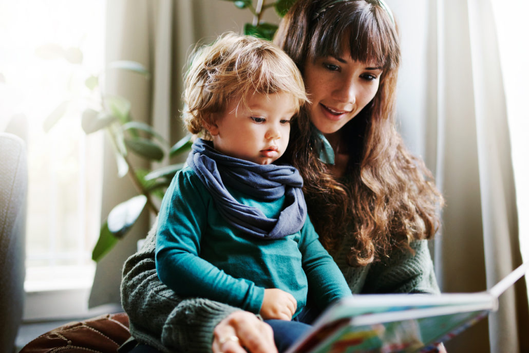 woman reading to her foster kid at home