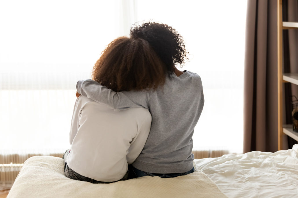 Foster mother and daughter in an embrace as rewards for fostering