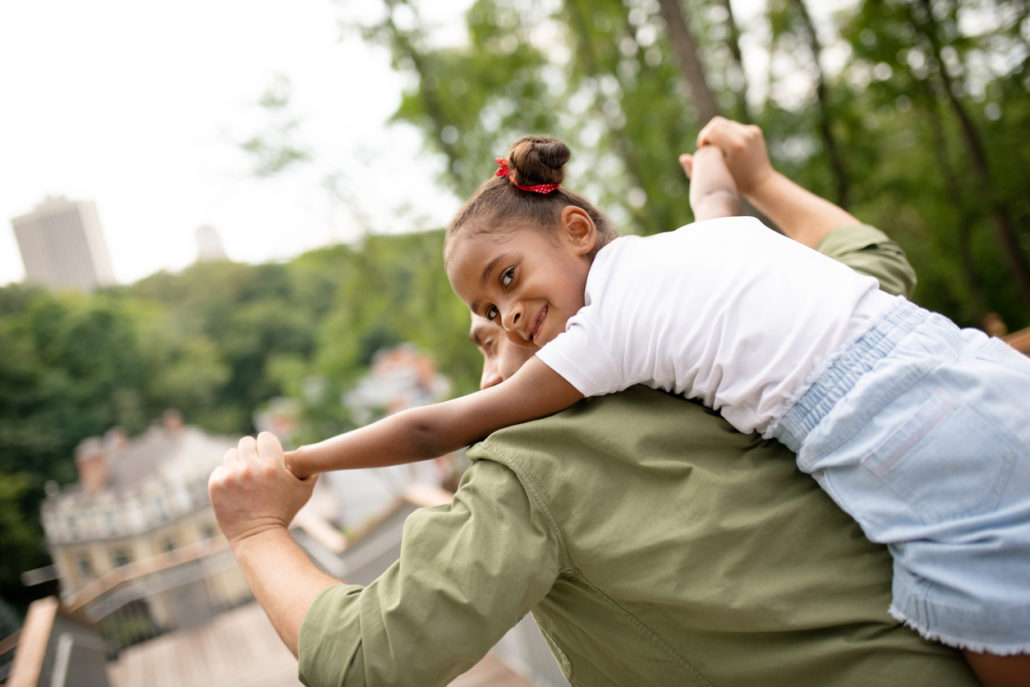 foster father lifting his Foster Placement on his shoulders